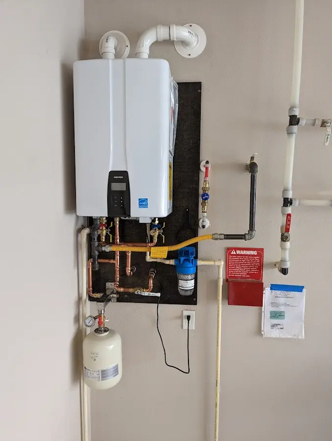 Professional plumber installing copper piping in a Derry home